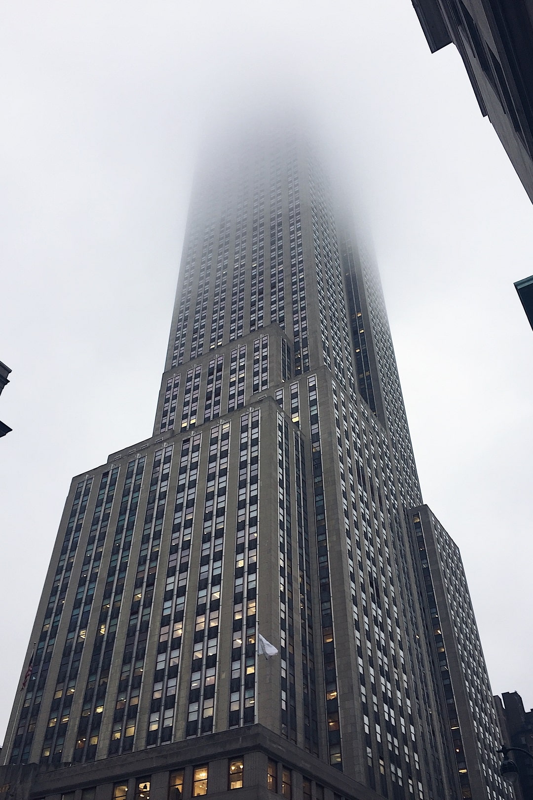 a photo I took of the Empire State Building with the top fading into the rainy cloudy light grey sky